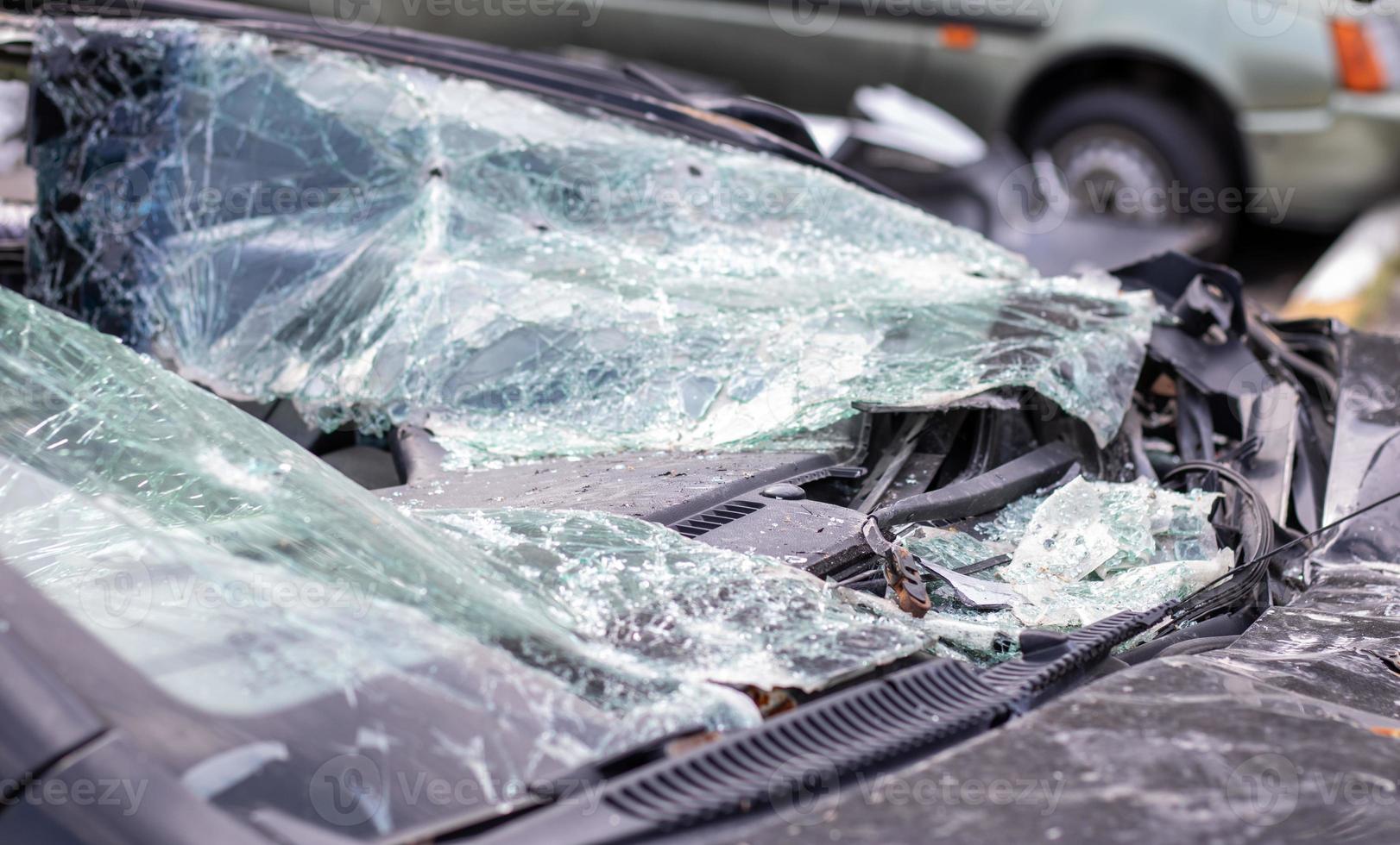 Close-up of a car with a broken windshield after a fatal crash. Consequence of a fatal car accident. Automobile danger. Reckless dangerous driving. Vehicle after an accident with a pedestrian. photo