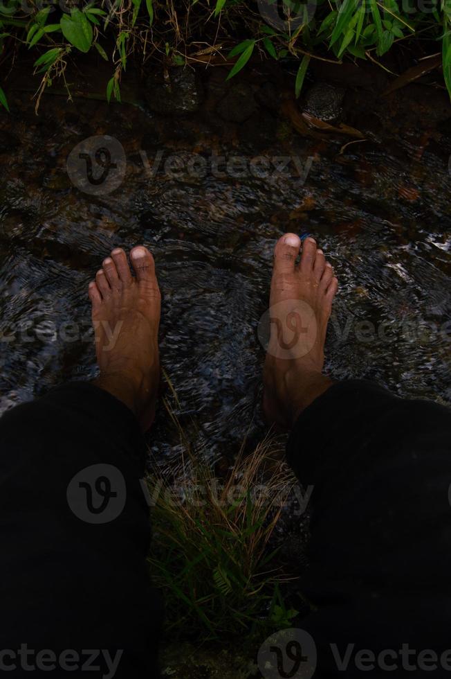 the feet of a person who is dwelling on clear water photo