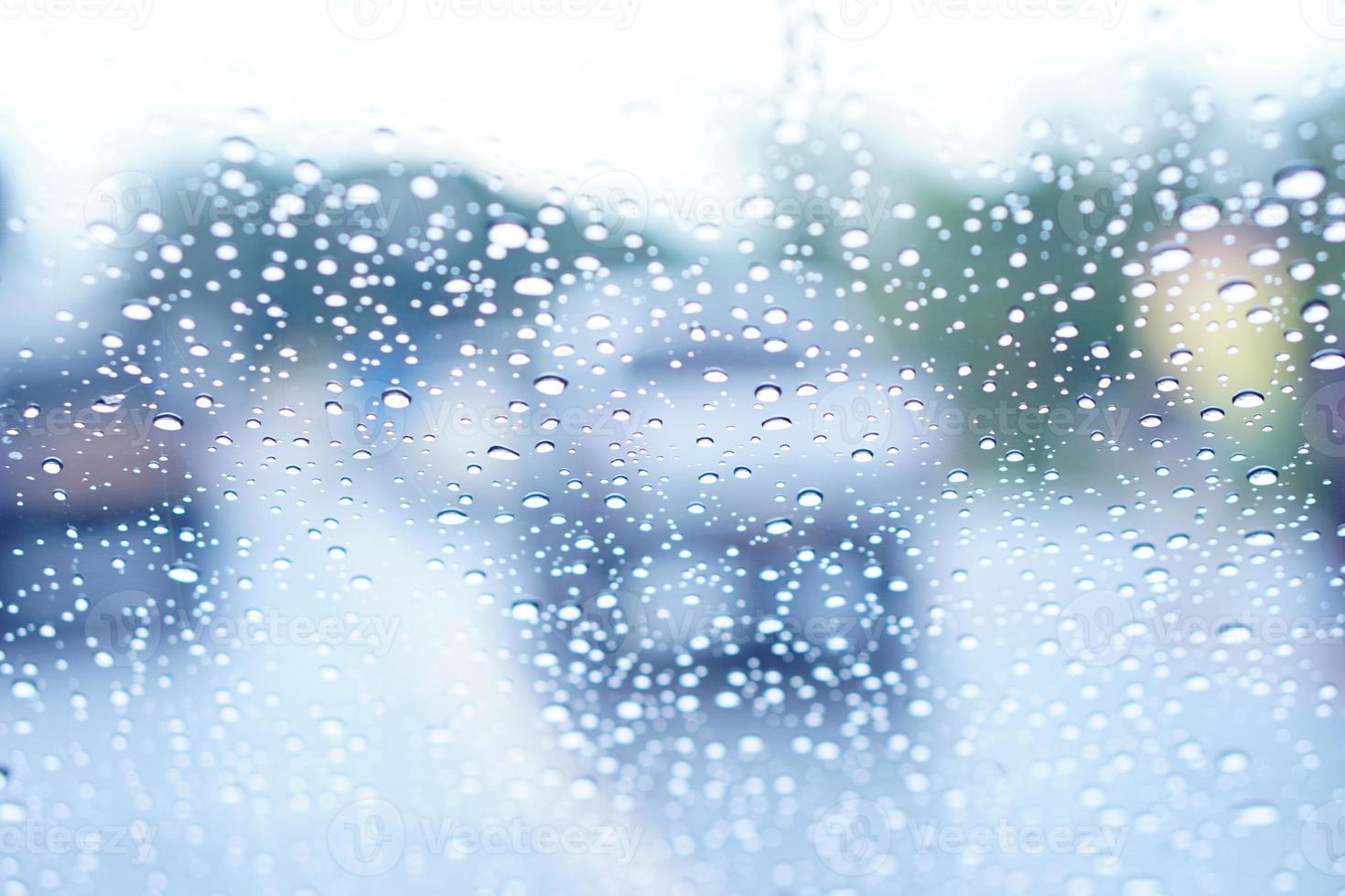 Blurred background of raindrops on the car windshield photo