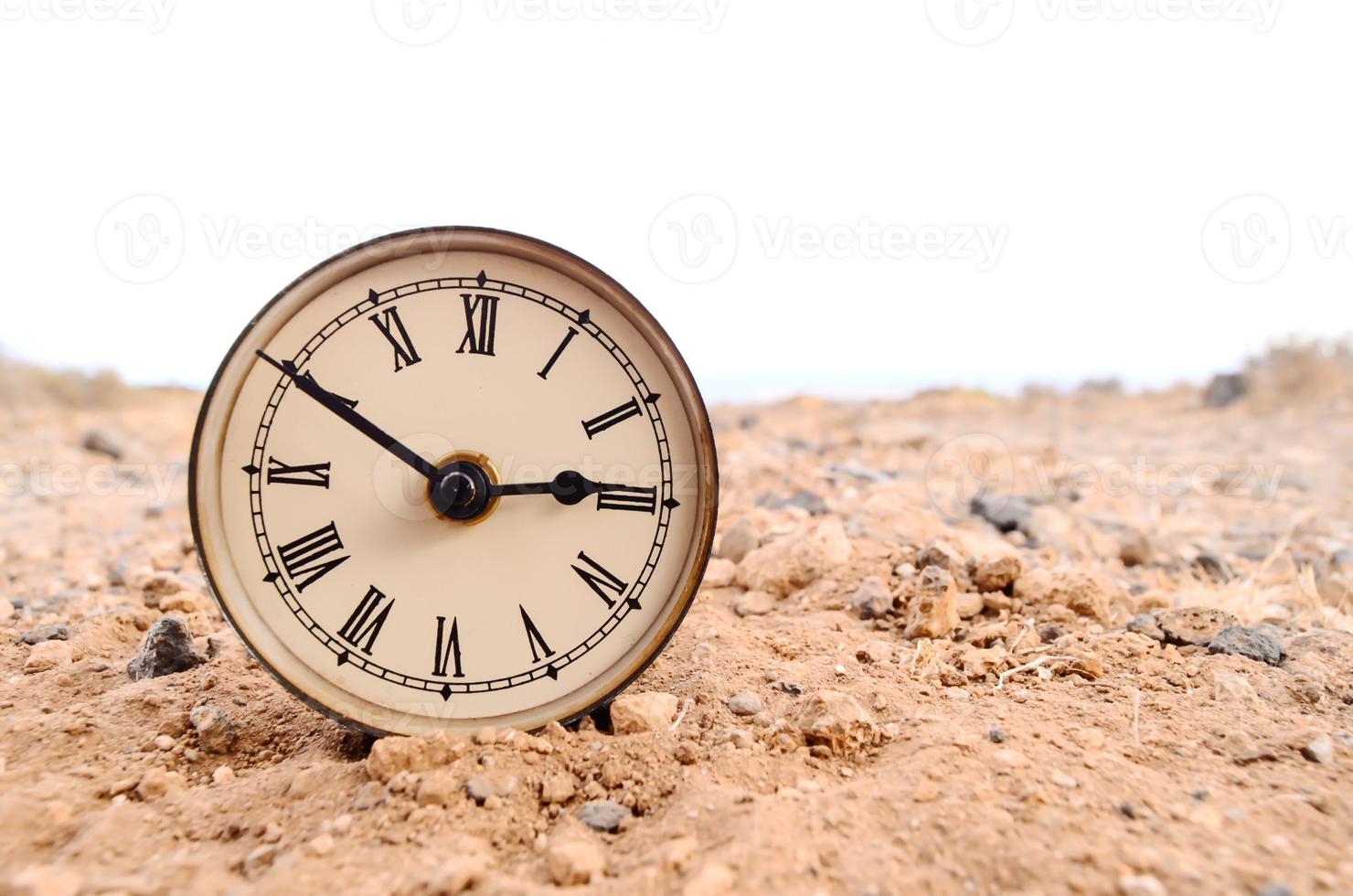 Classic Analog Clock In The Sand photo