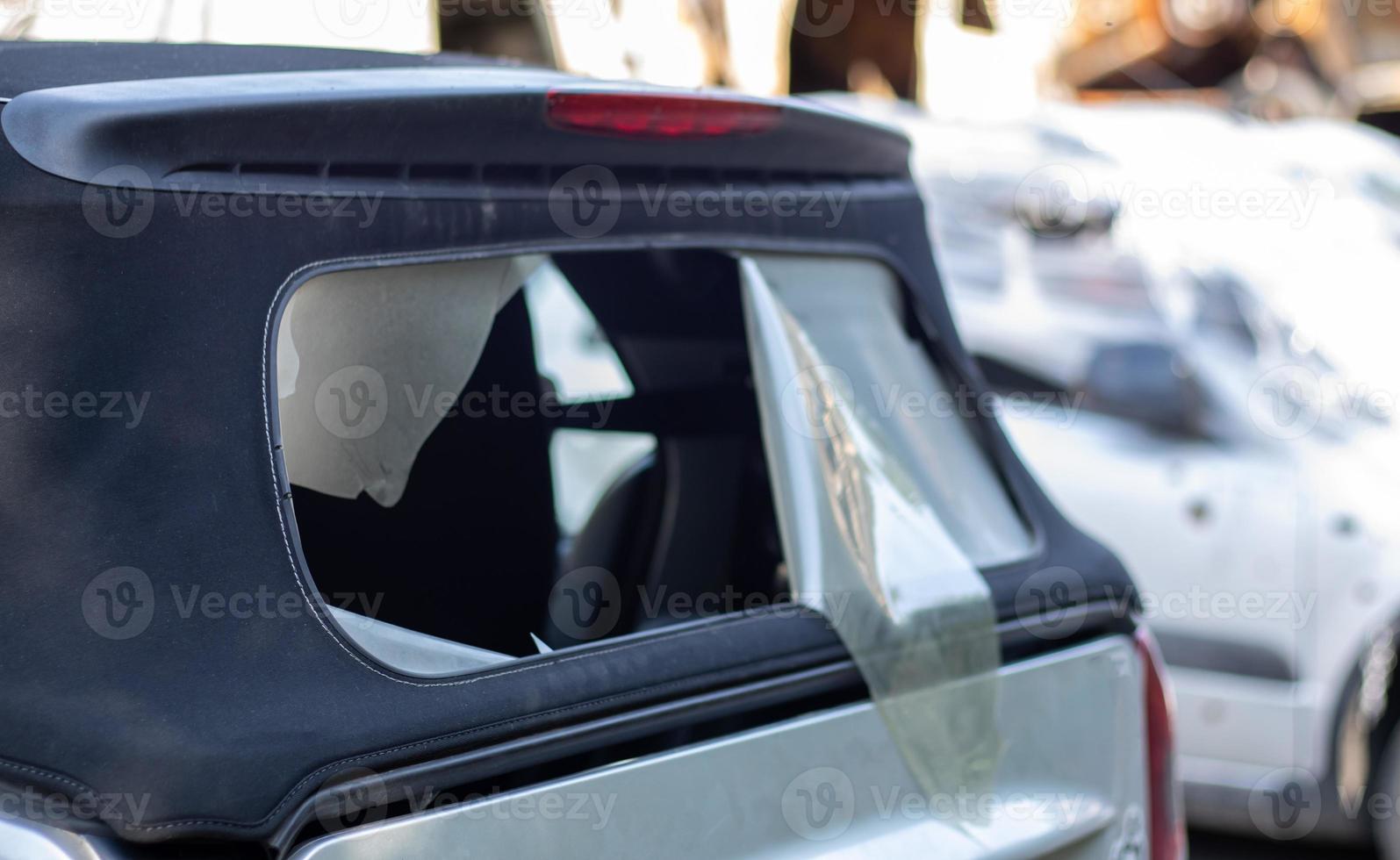 Damaged roof material on the back of the convertible. Vandalism, thieves cut the roof of a convertible from behind. Theft of things from the car. Criminal incident. Car burglary. photo