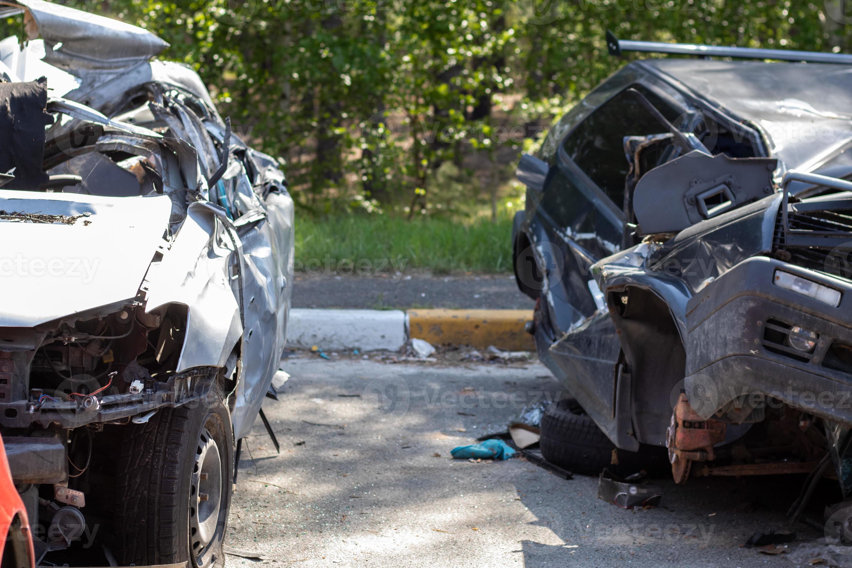 Many broken cars after a traffic accident in the parking lot of a  restoration service station on the street. Car body damage workshop  outdoors. Sale of insurance emergency vehicles at auction. 8281183