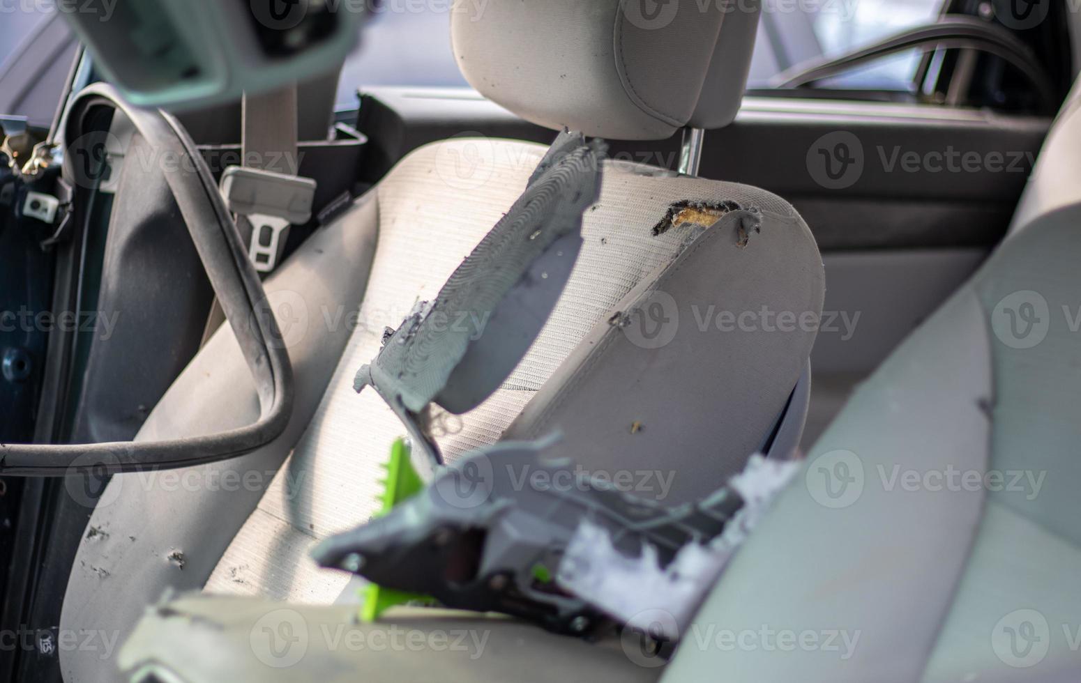 The interior of the car is damaged after the accident, broken glass on the seat. Damaged car interior. photo