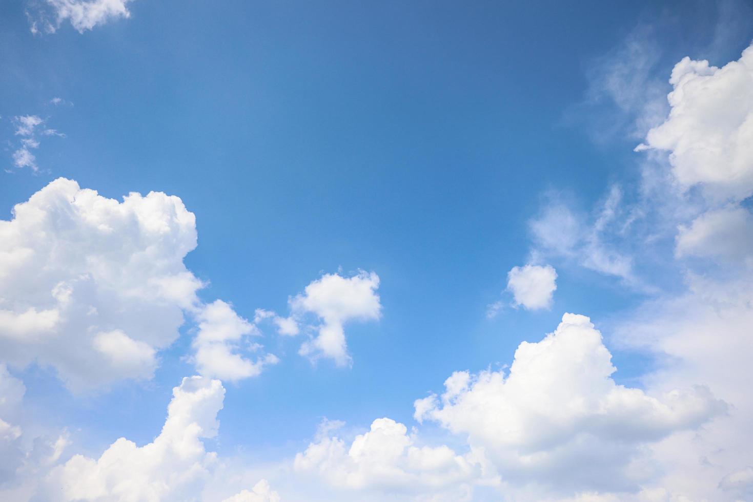 Bright day clean fresh blue sky with white soft clouds in sunlight photo