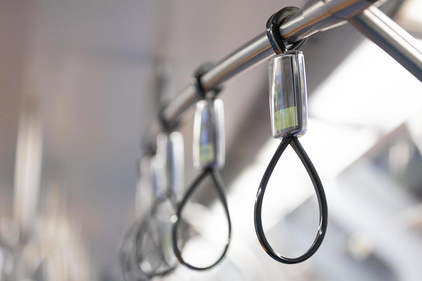 Closeup of the hand holders in bus or train for passengers body balance supporting. photo