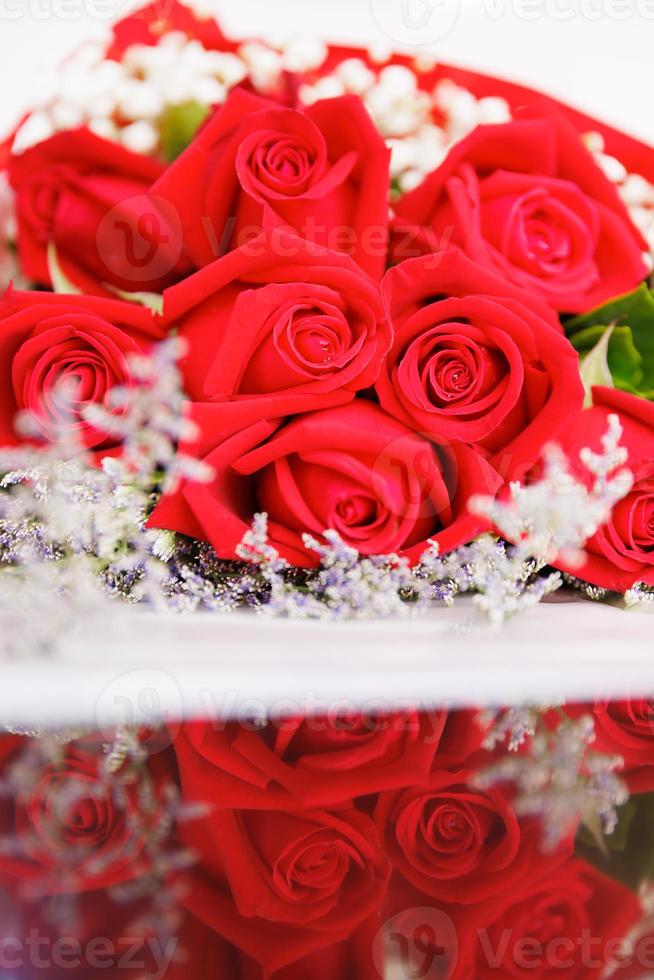A big, elegance and luxury bouquet made of red roses with reflection on floor photo