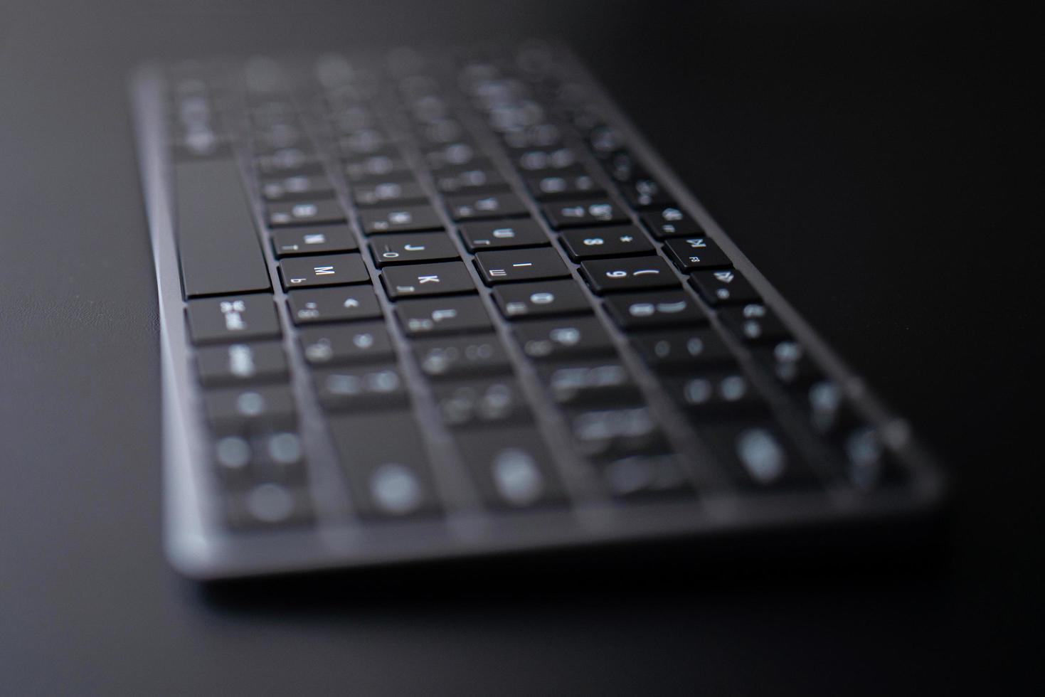 space gray keyboard on a black background photo