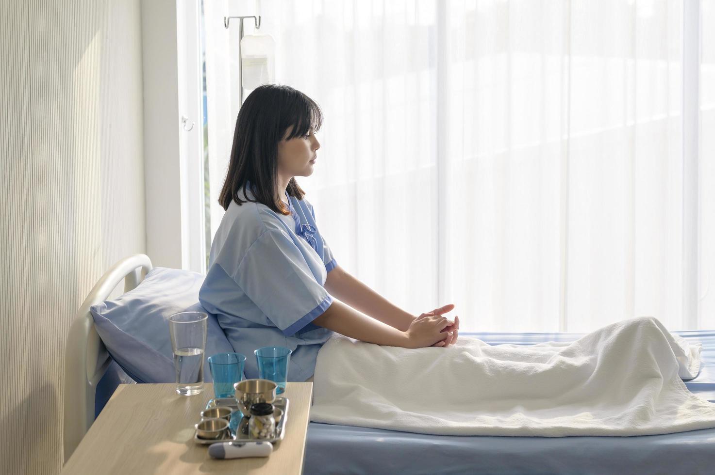 Hopeful and happy young patient woman in hospital, healthcare and medical concept photo
