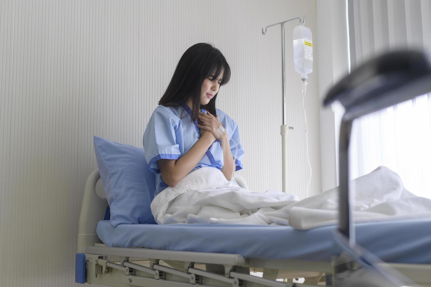 A despondent Asian woman patient. Following the doctor's declaration that the cancer was nearing the end of its course. photo