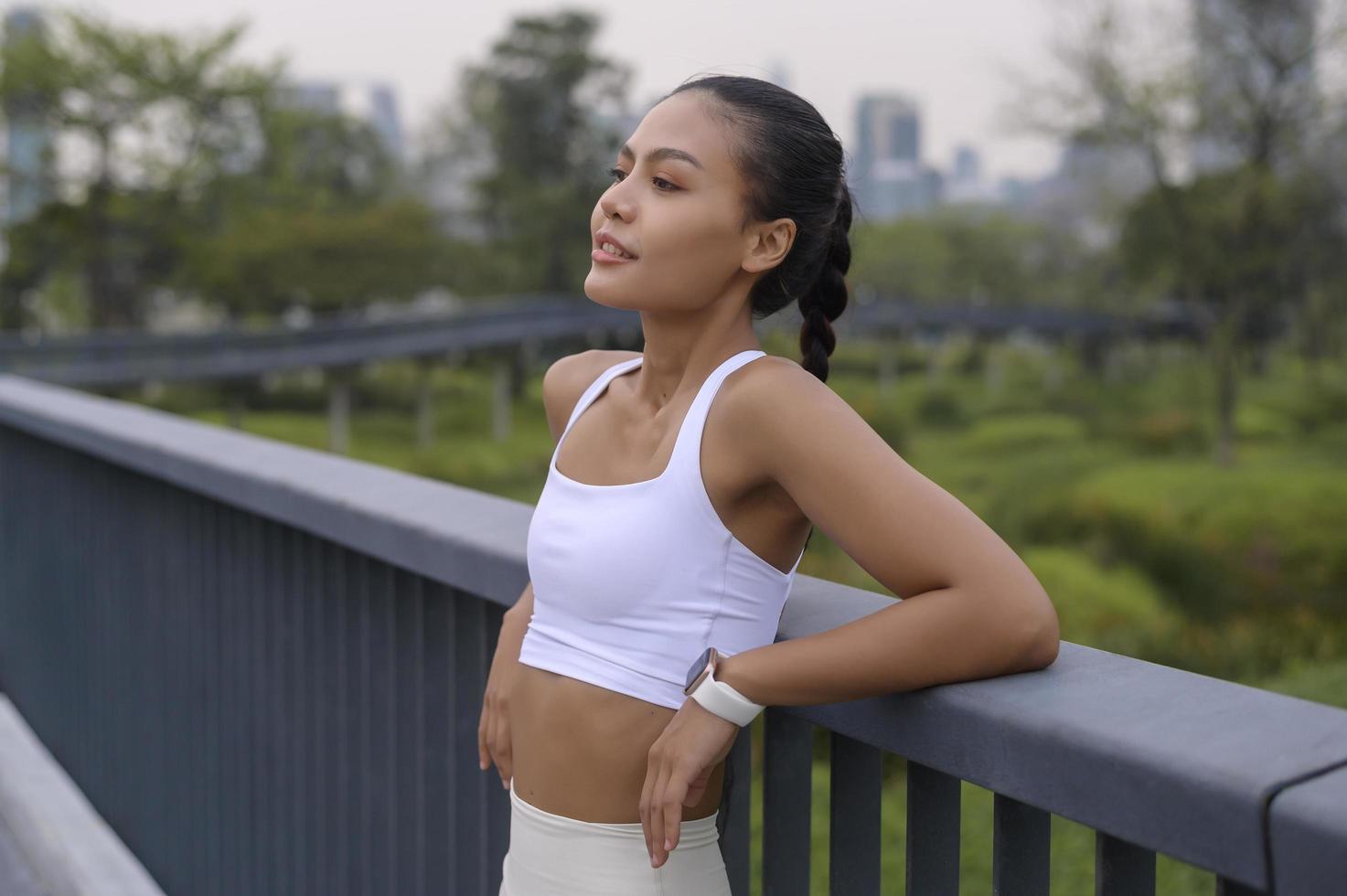 Portrait of young fitness woman in sportswear in city park, Healthy and Lifestyles. photo