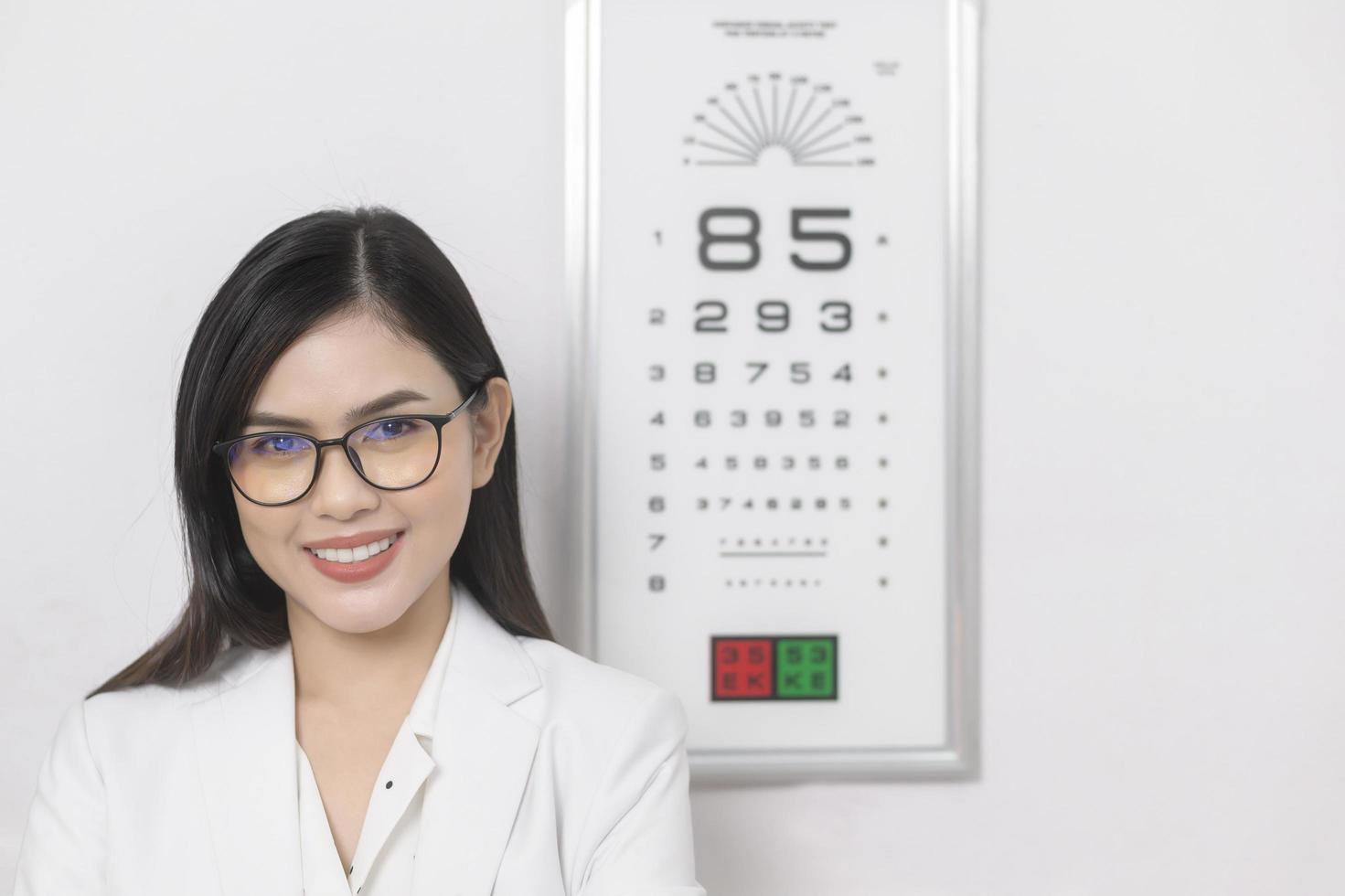Young ophthalmologist doing visual test for customer using eye chart in