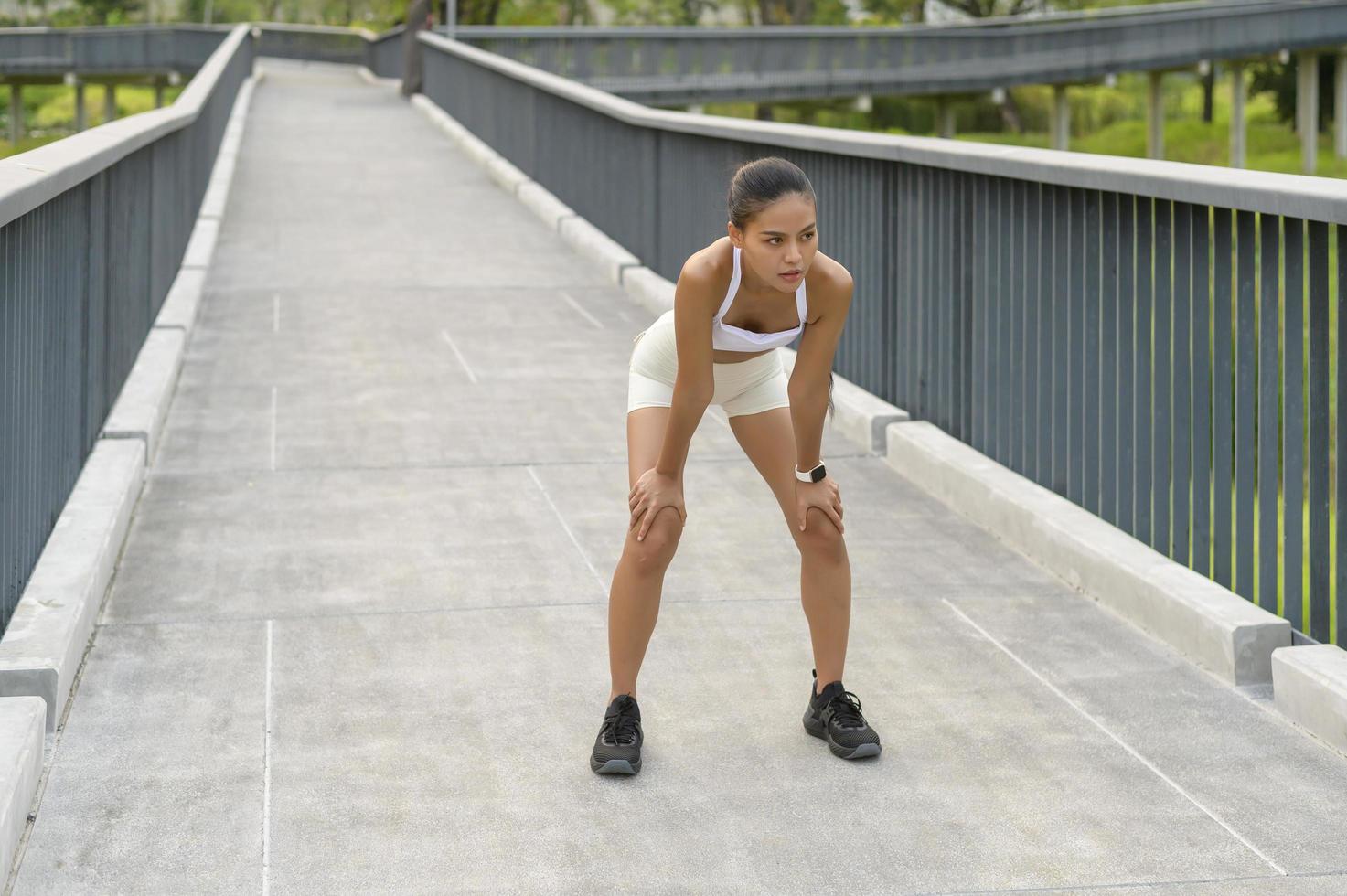 Young fitness woman in sportswear tired and exhausted in city park, Healthy and Lifestyles. photo