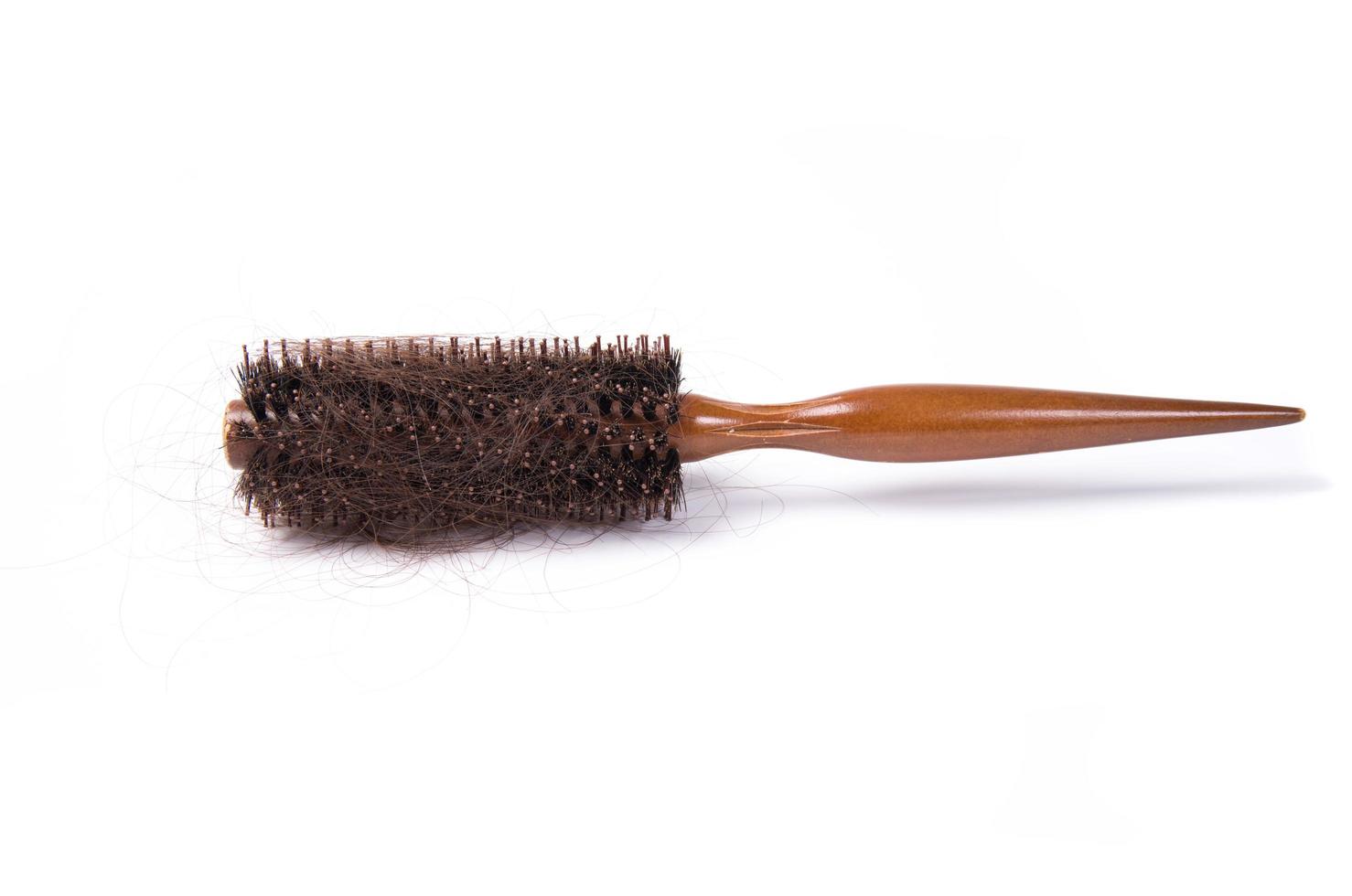 round hair brush with lost hair on white background photo