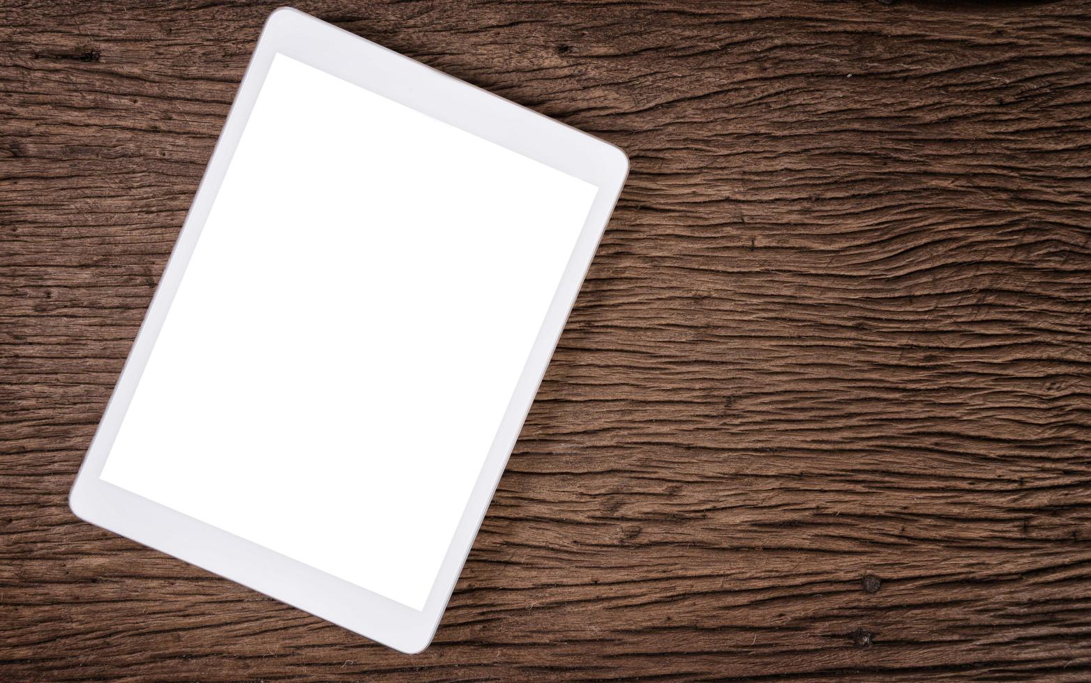 tableta blanca tablet pc en mesa de madera foto