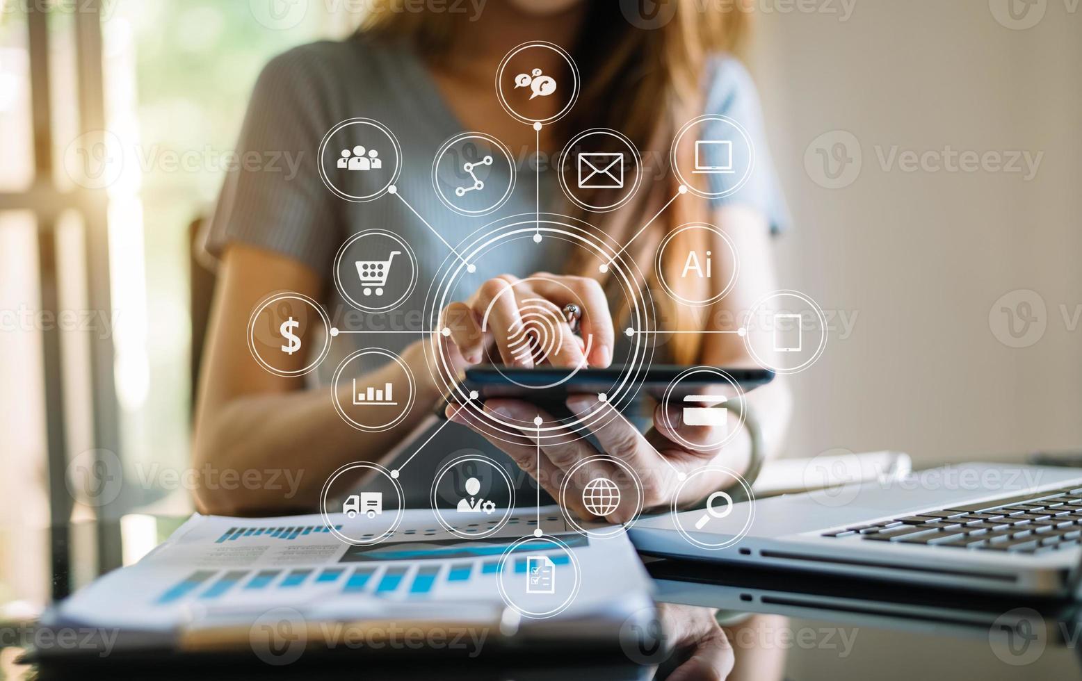 businesswoman or Designer using mobile phone with laptop and digital tablet laptop and document on desk in office photo