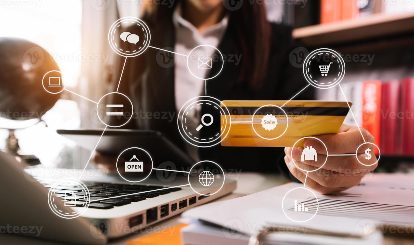 Close up of Hand using credit card and smartphone, laptop computer on wooden desk with VR icon chart  diagram photo