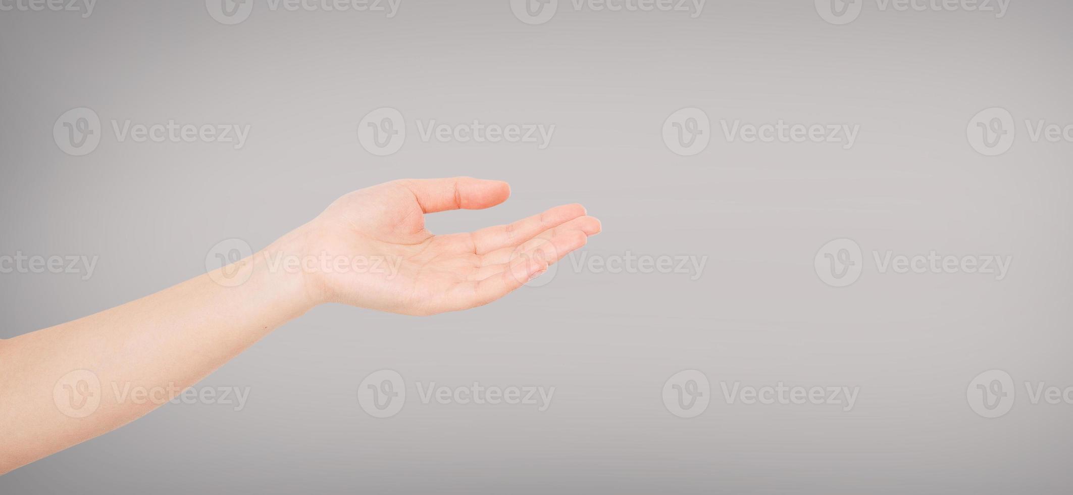 open Female hand on grey background copy space photo