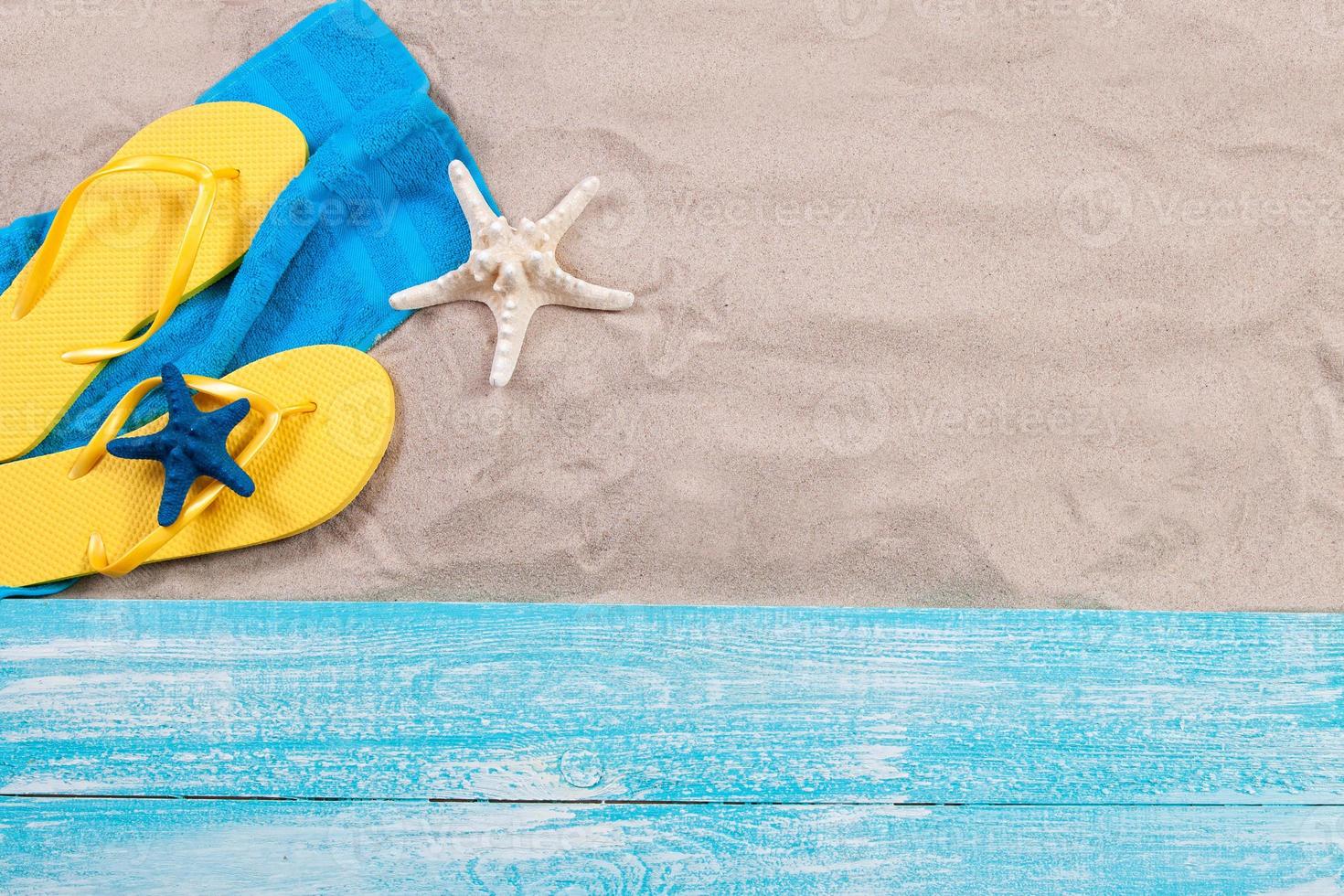 Sand copy space. Sand background top view.Beach towel, beach slippers and starfish photo