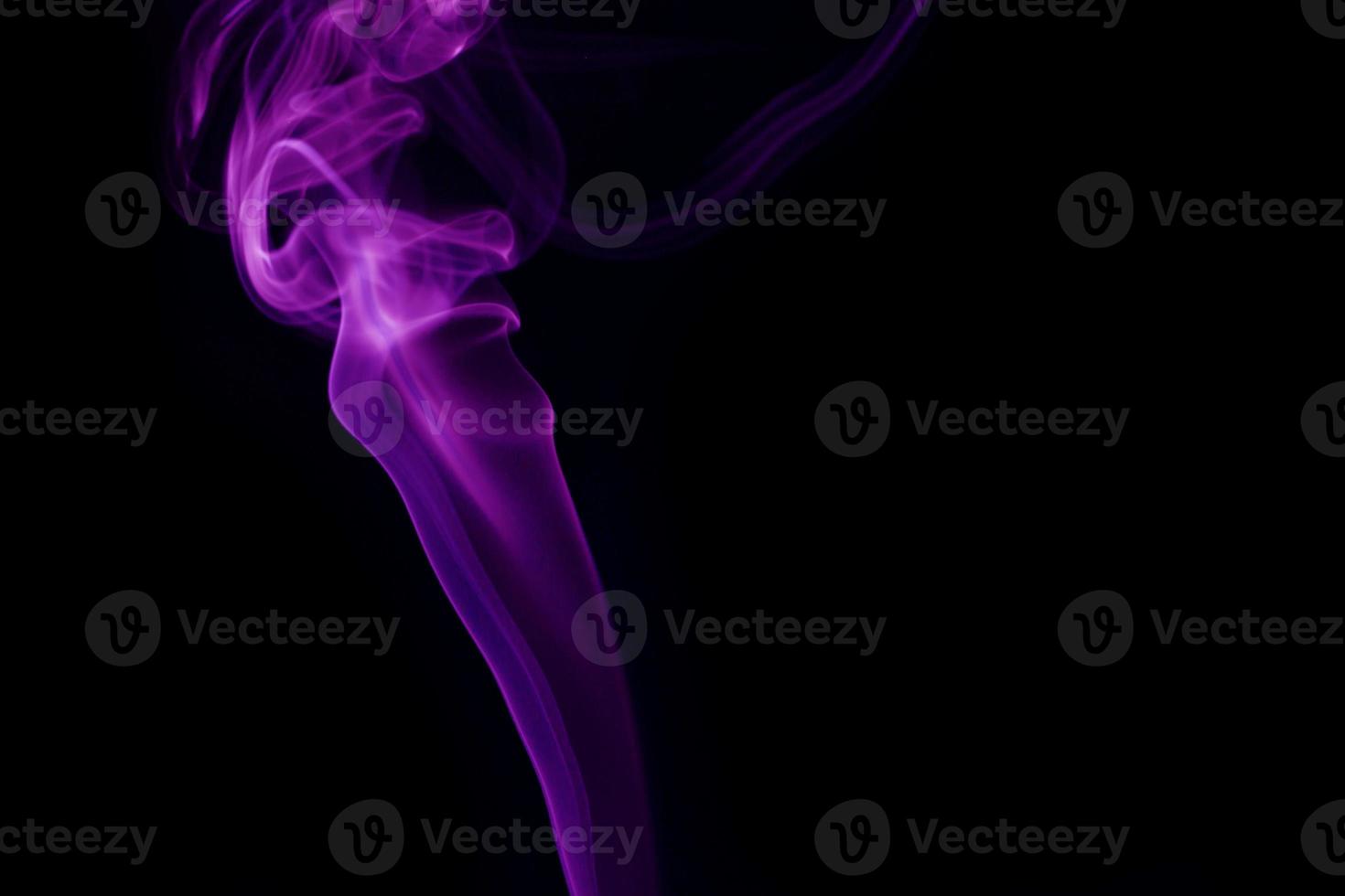 Purple smoke on black background photo