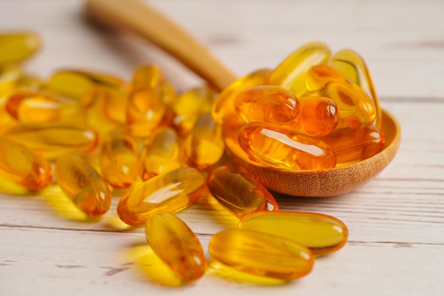 Fish oil or Cod liver oil gel in capsules with omega 3 vitamins, supplementary healthy food photo