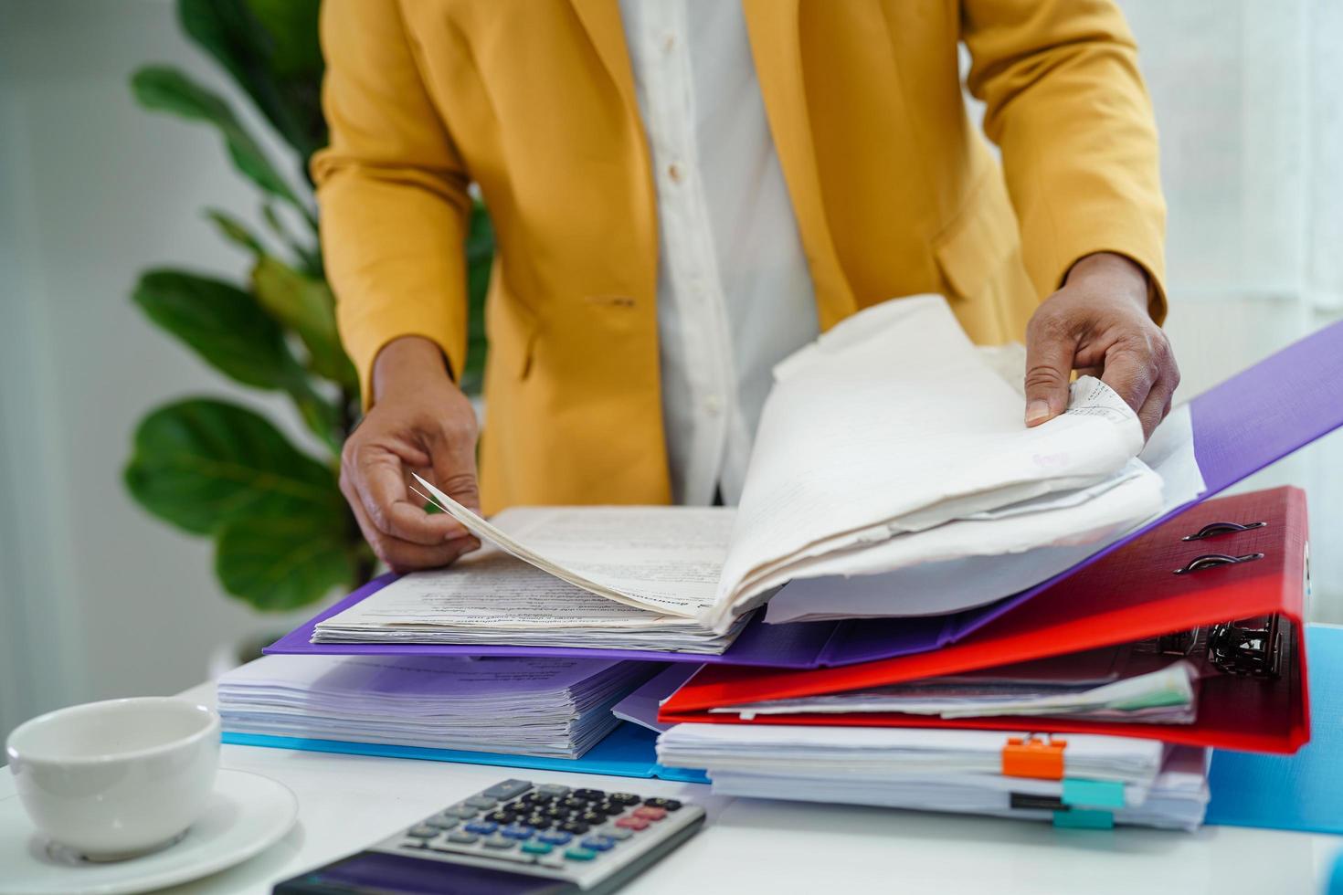 Businessman working and prepare paperwork report data to analysis information in file binder at office. photo