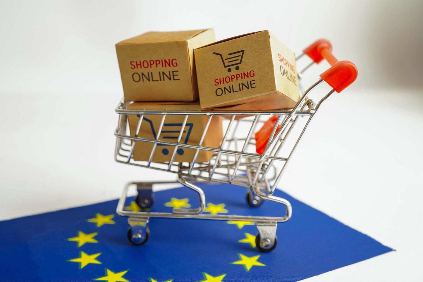 Online shopping, Shopping cart box on EU flag, import export, finance commerce. photo