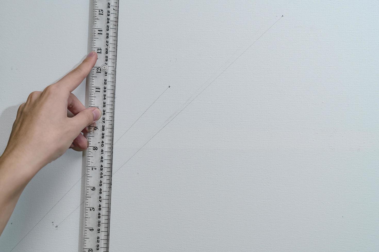 hand holding ruler with canvas background photo