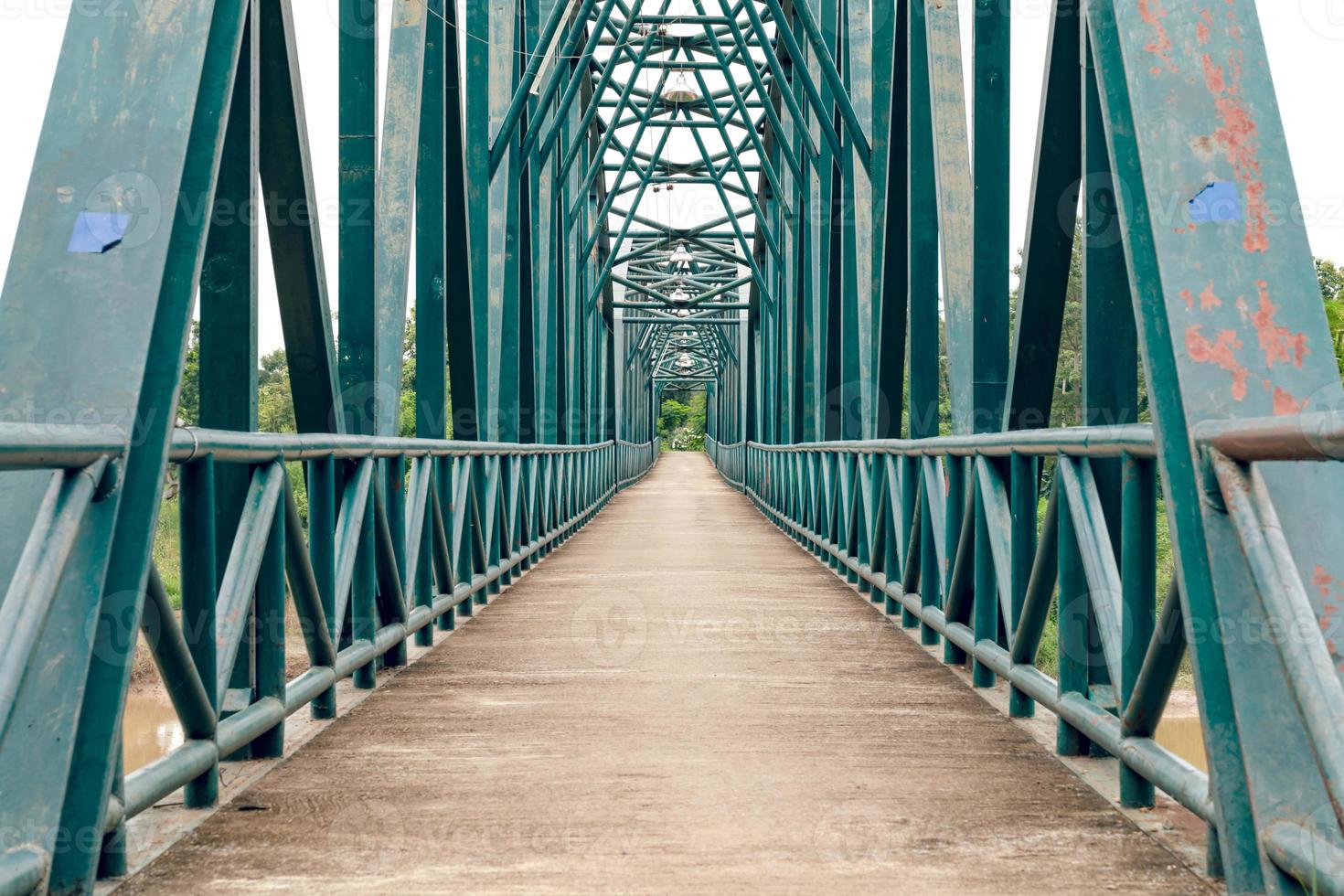Green iron bridge across the river photo