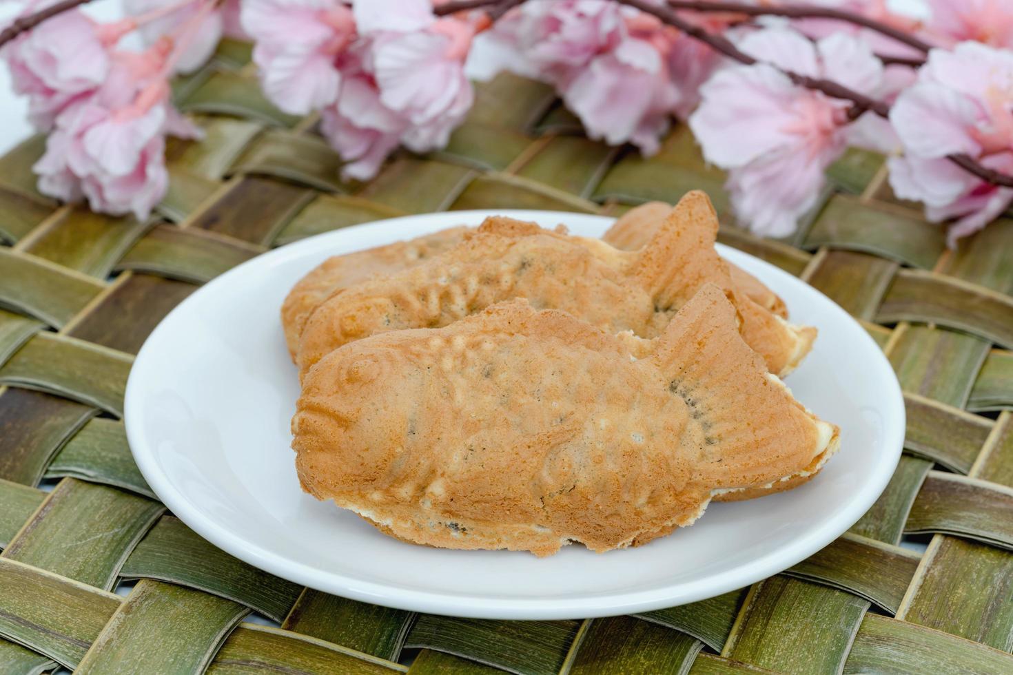 Taiyaki cakes in white dish with cherry blossom,Japanese confectionery photo