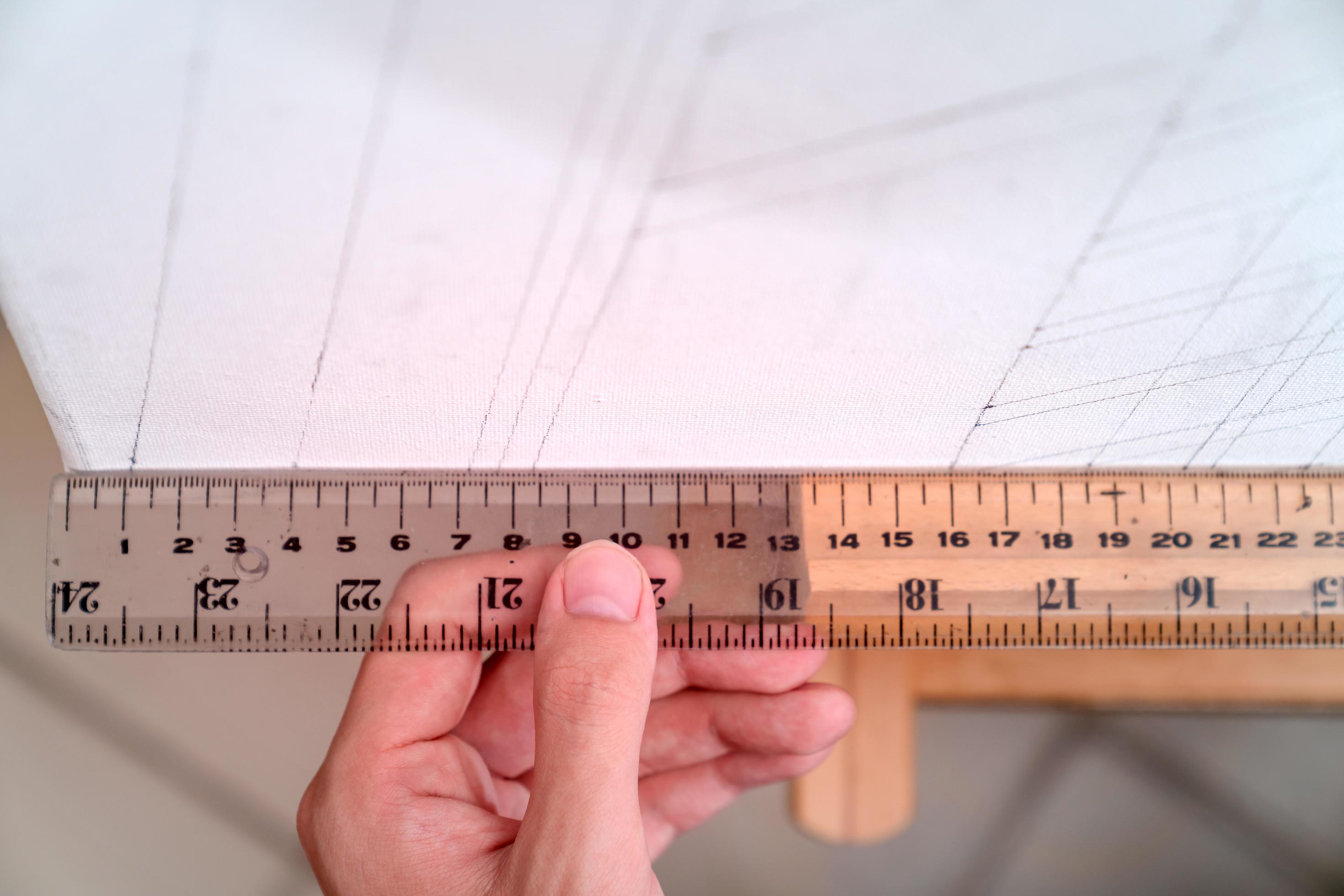 hand holding ruler with canvas background 8289840 Stock Photo at Vecteezy