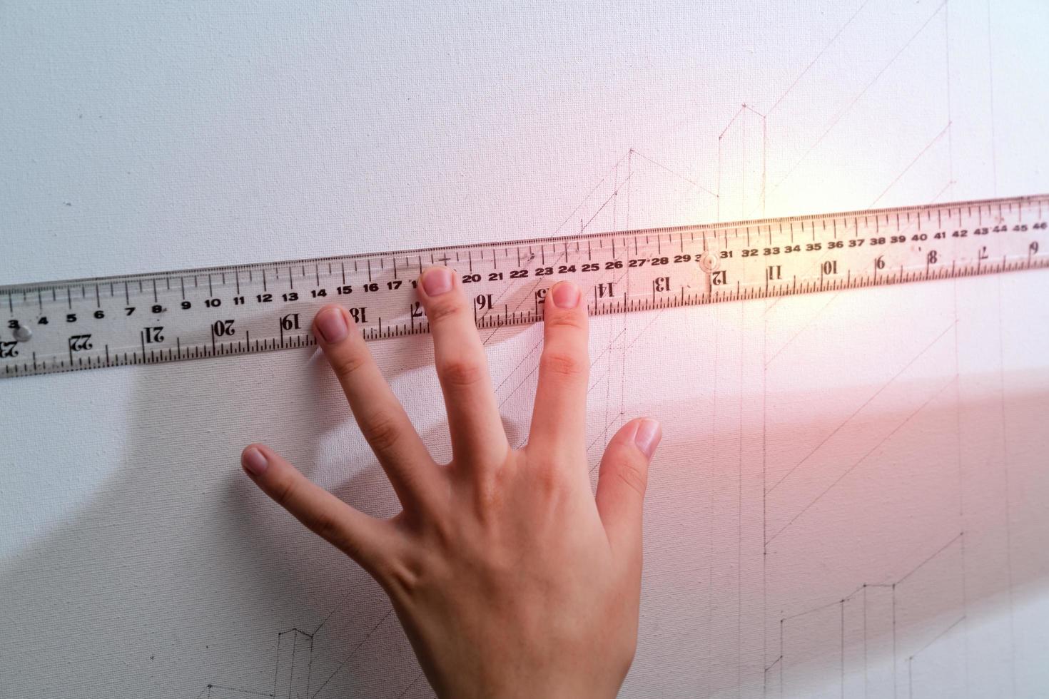 hand holding ruler with canvas background photo