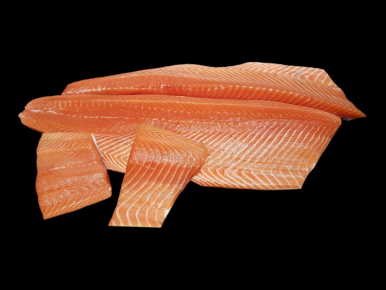Piece of fresh salmon fillet isolated on black background photo