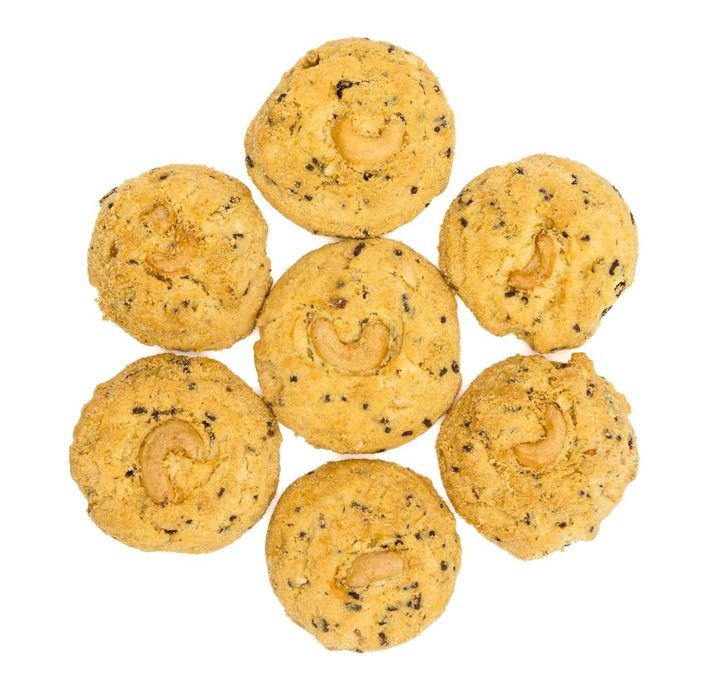 butter cookies with cashew nuts isolated on white background, top view photo