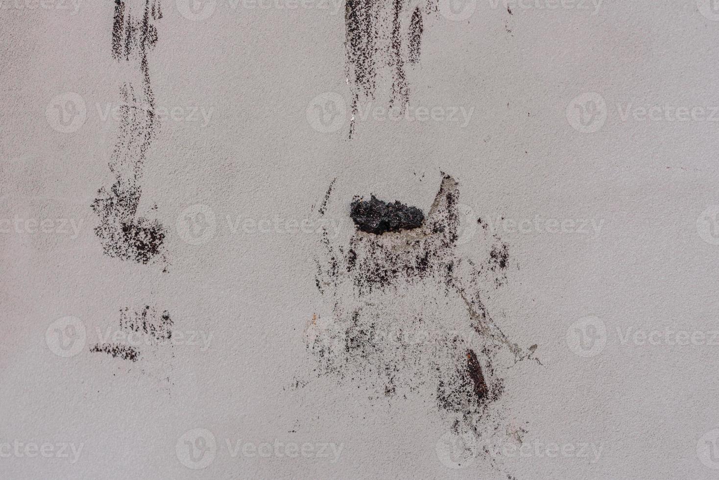 Texture of a concrete wall with cracks and scratches which can be used as a background photo