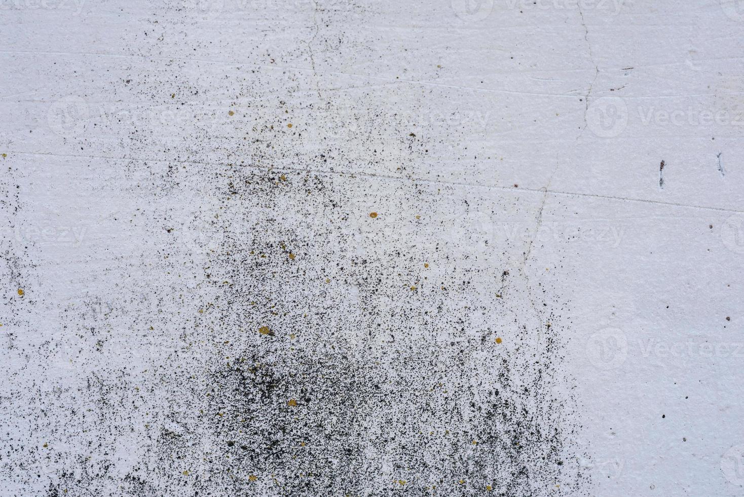 Texture of a concrete wall with cracks and scratches which can be used as a background photo