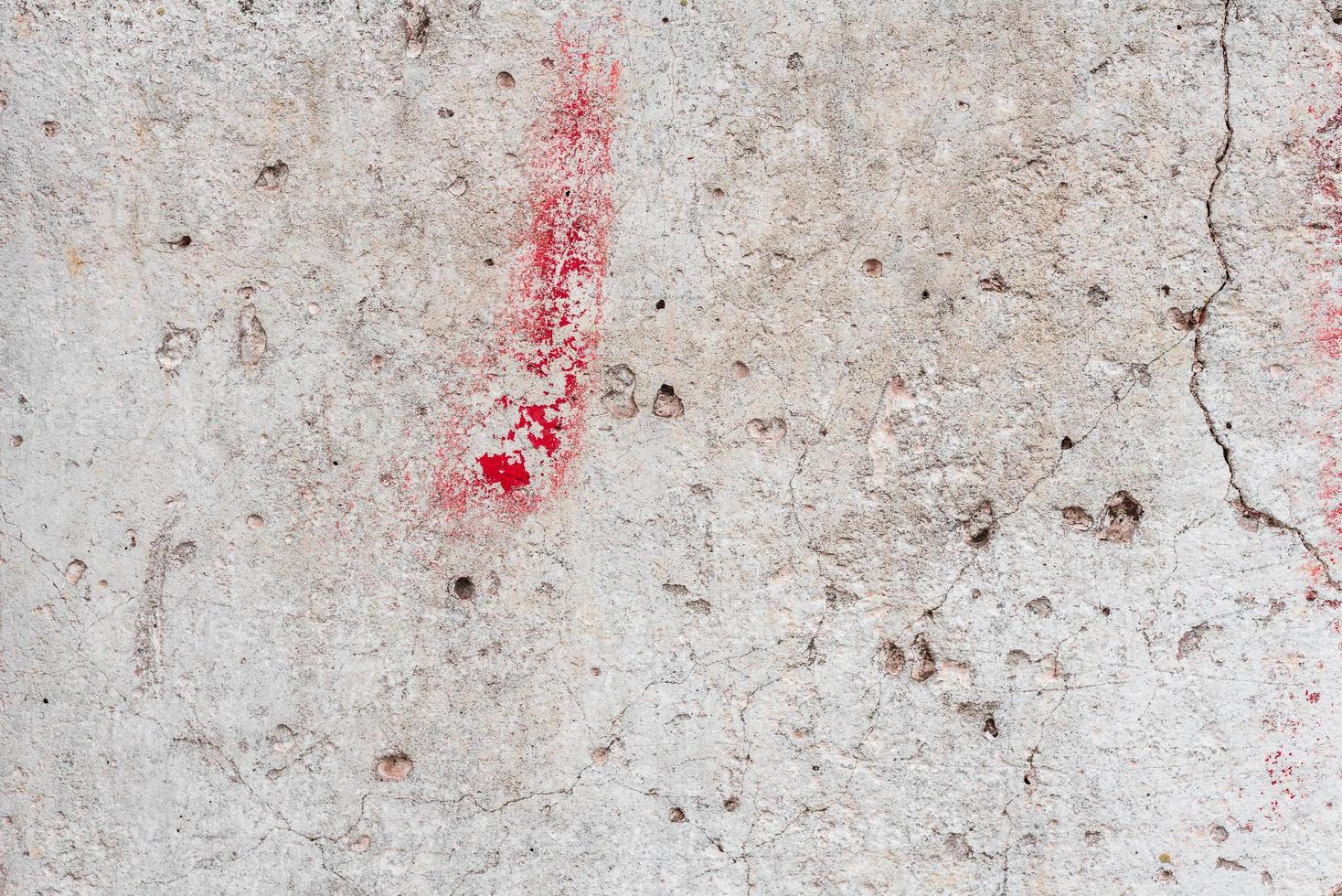Texture of a concrete wall with cracks and scratches which can be used as a background photo
