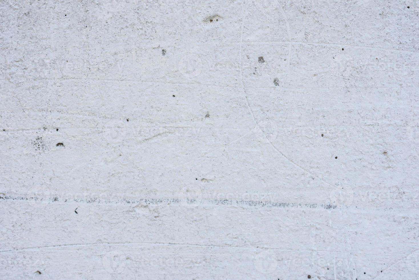 Texture of a concrete wall with cracks and scratches which can be used as a background photo