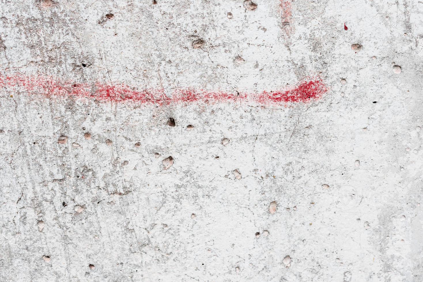 Texture of a concrete wall with cracks and scratches which can be used as a background photo
