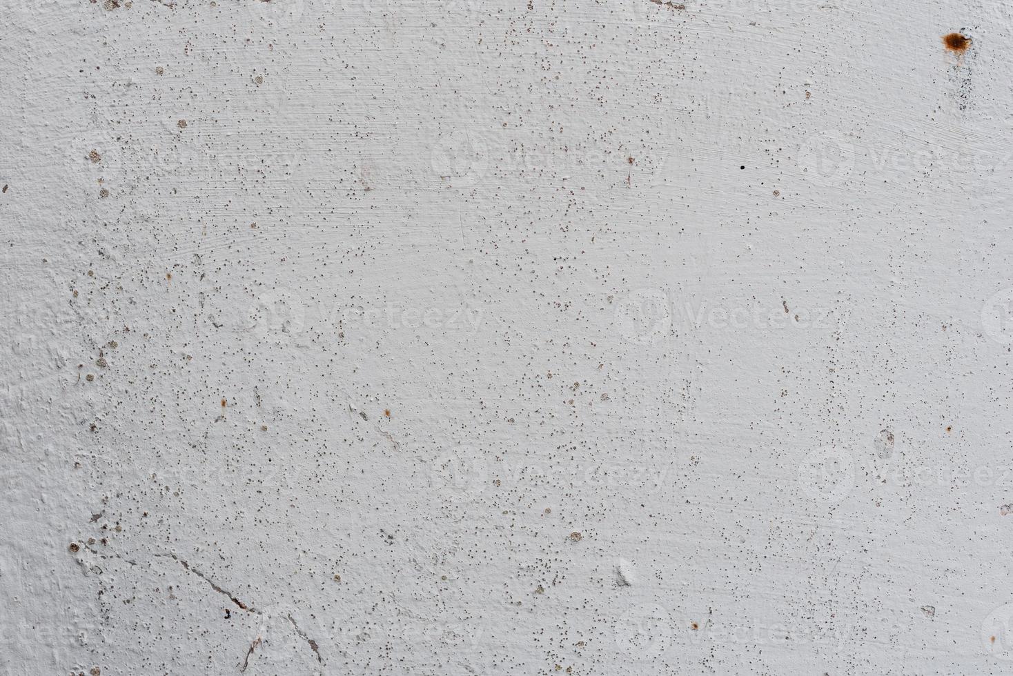 Texture of a concrete wall with cracks and scratches which can be used as a background photo