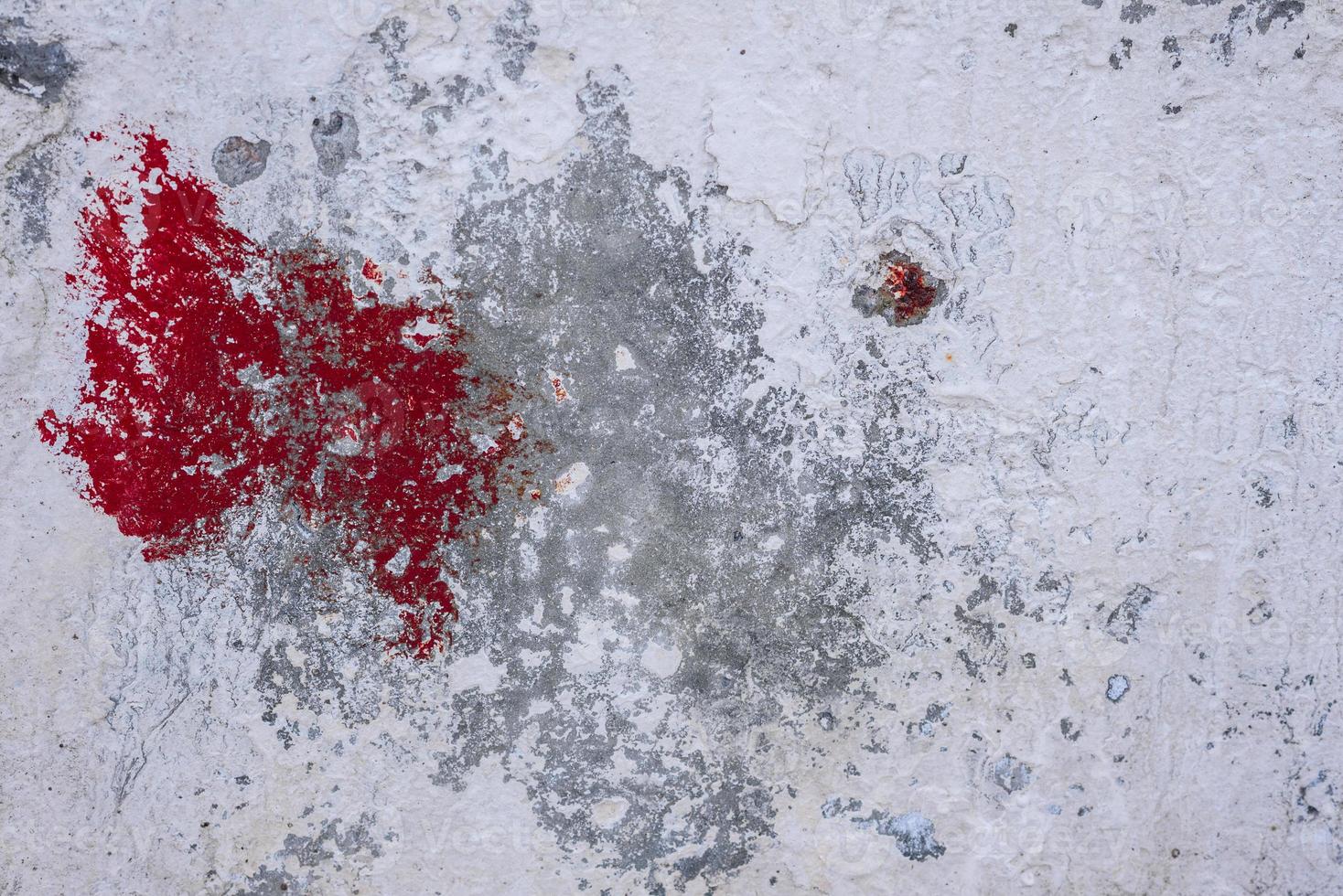 Texture of a concrete wall with cracks and scratches which can be used as a background photo