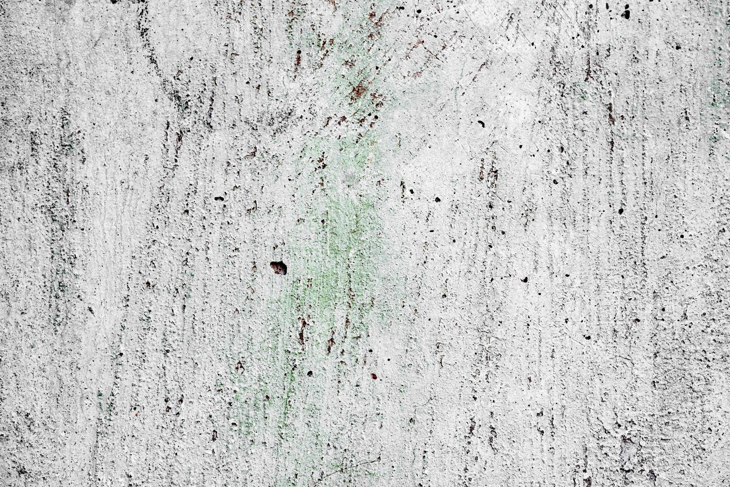 Texture of a concrete wall with cracks and scratches which can be used as a background photo