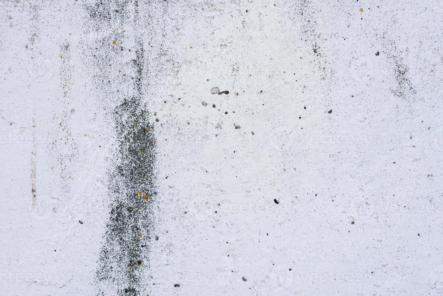 Texture of a concrete wall with cracks and scratches which can be used as a background photo