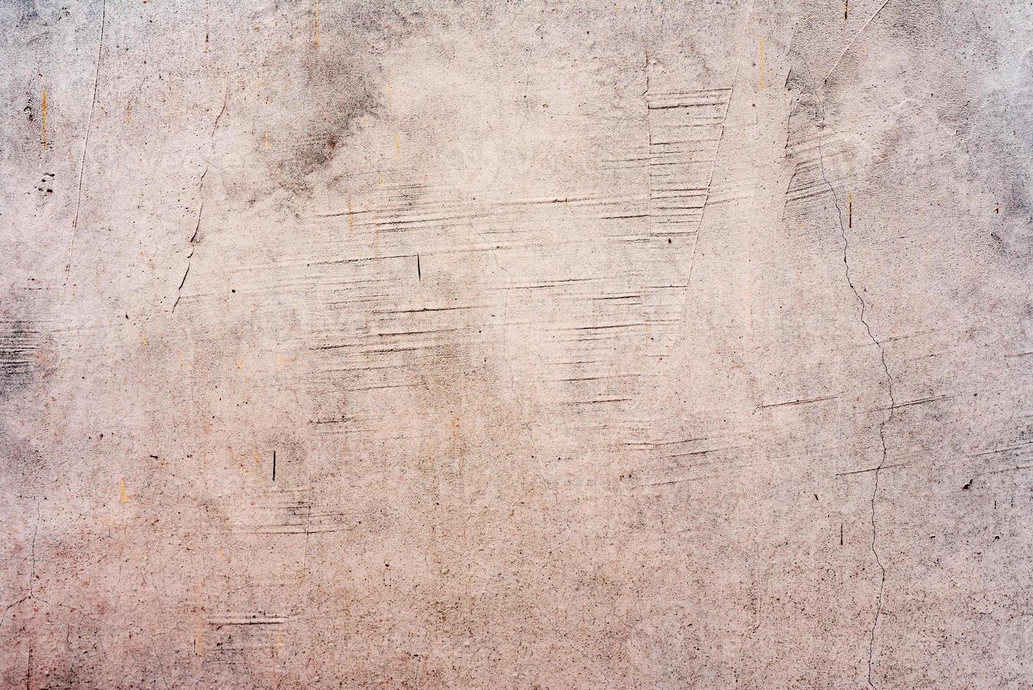 Texture of a concrete wall with cracks and scratches which can be used as a background photo