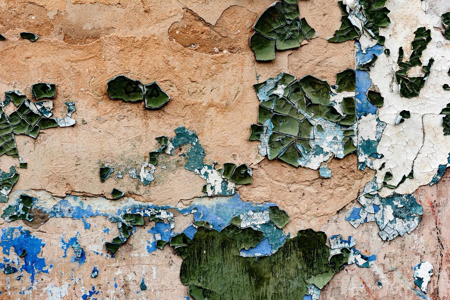 Texture of a brick wall with cracks and scratches which can be used as a background photo