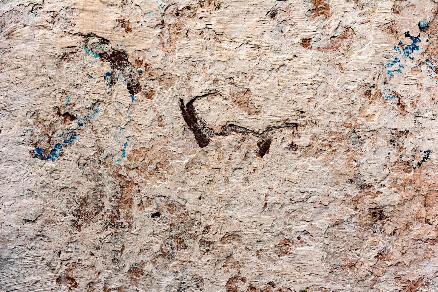 Texture of a concrete wall with cracks and scratches which can be used as a background photo