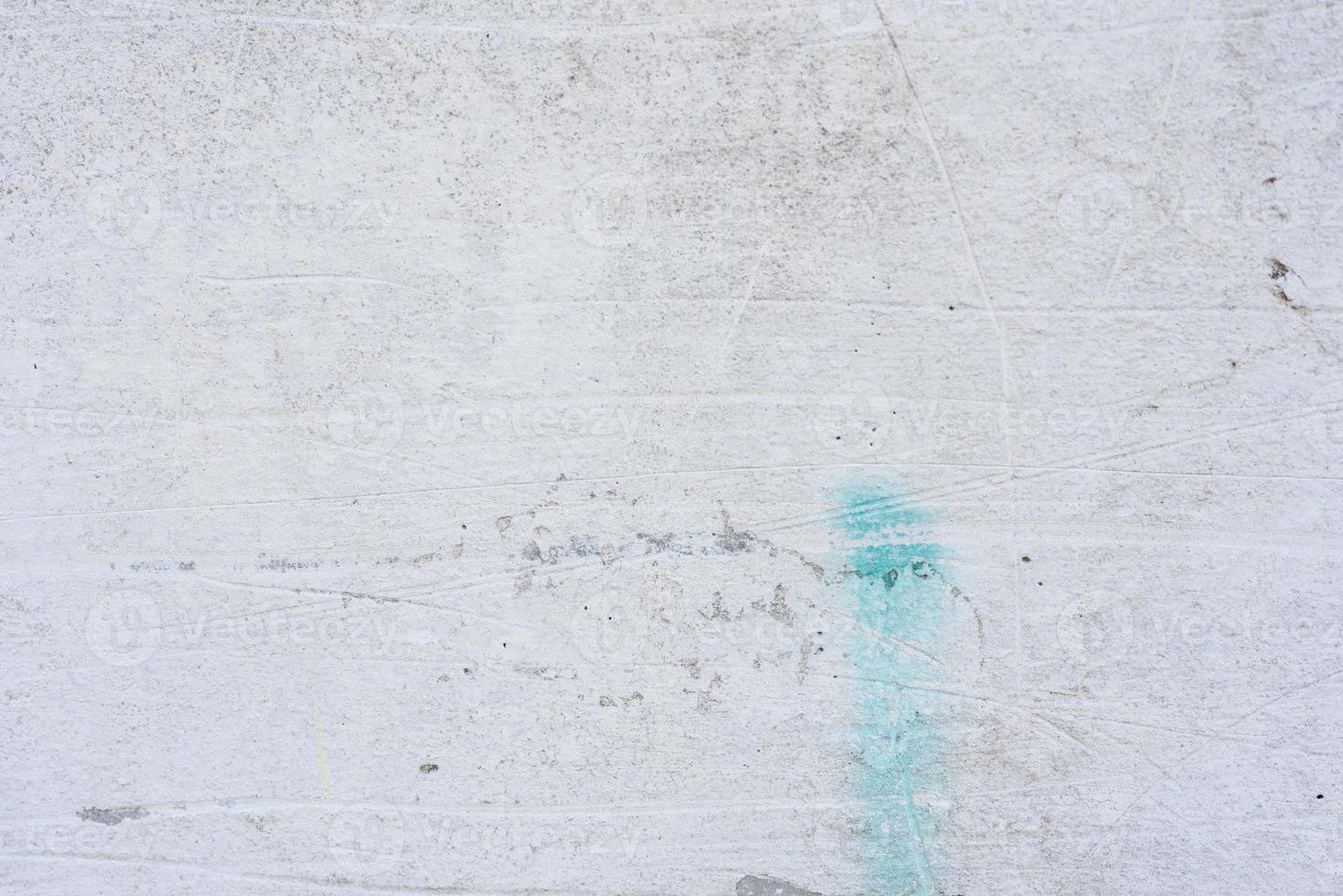 Texture of a concrete wall with cracks and scratches which can be used as a background photo