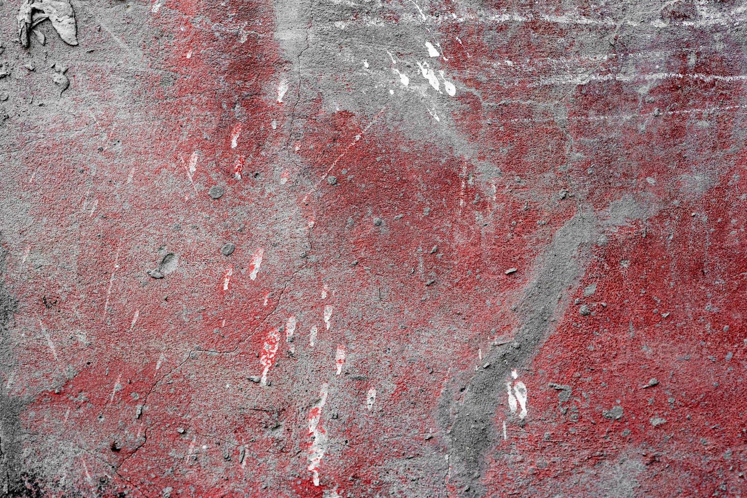 Texture of a concrete wall with cracks and scratches which can be used as a background photo