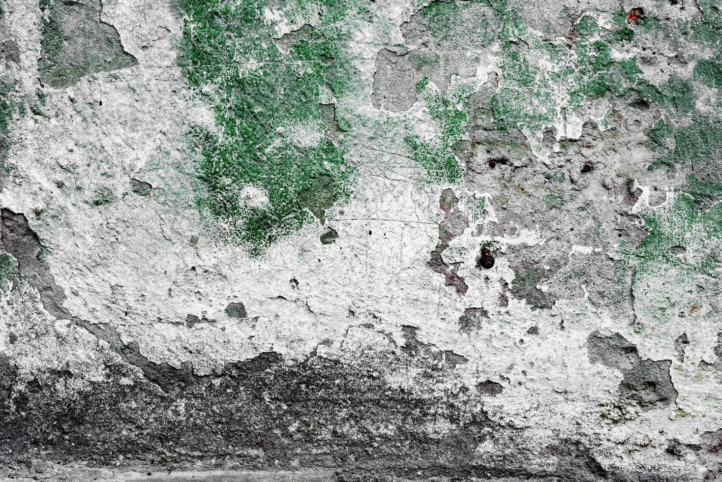 Texture of a concrete wall with cracks and scratches which can be used as a background photo