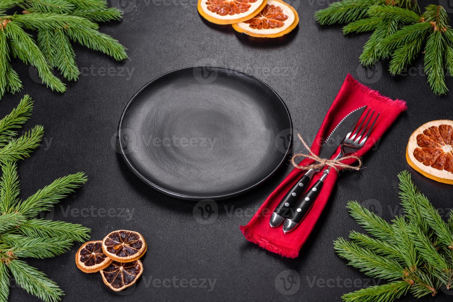 Festive Christmas table with appliances, gingerbreads, tree branches and dried citrus trees photo