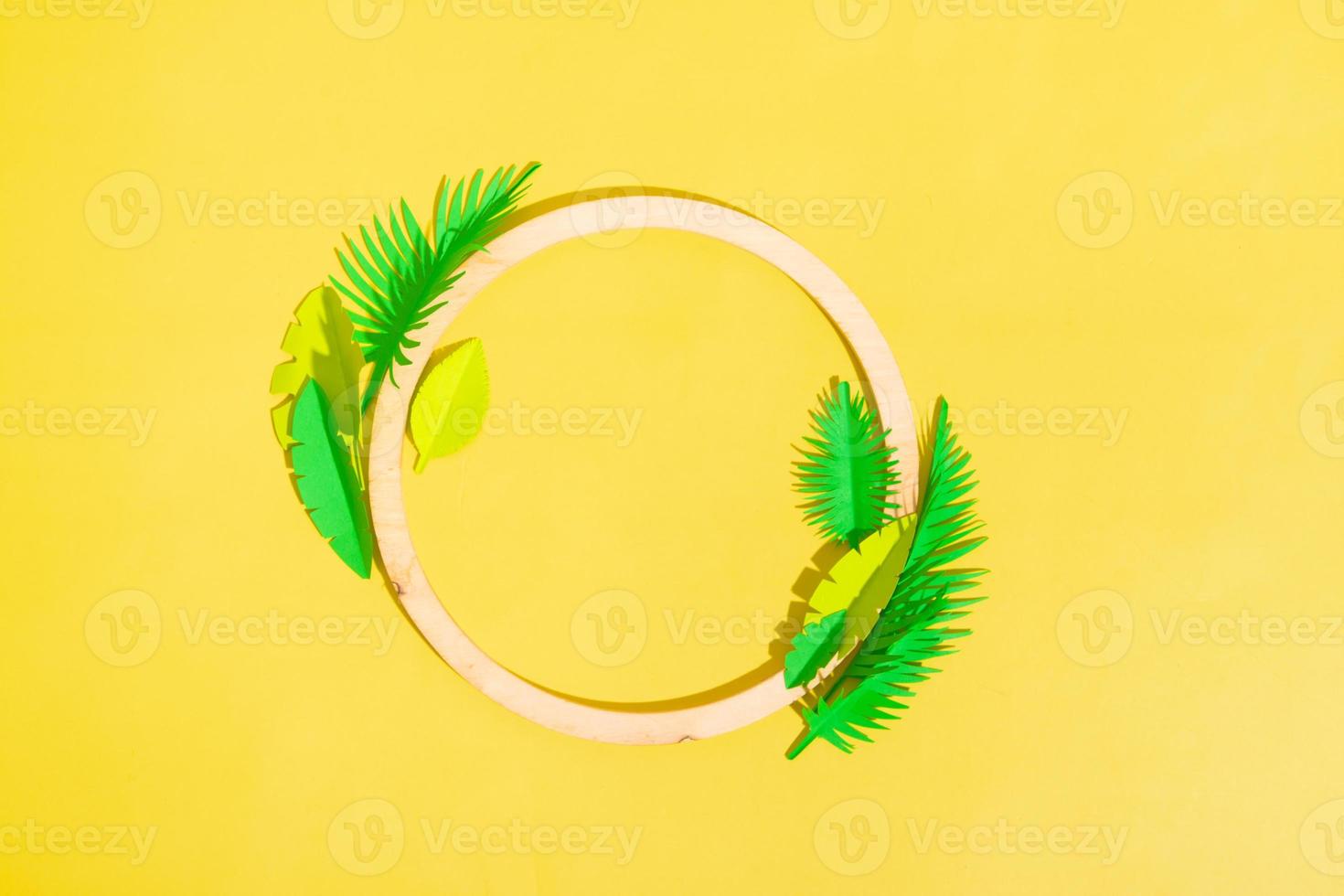 Wooden frame with tropical leaves with copy space top view photo